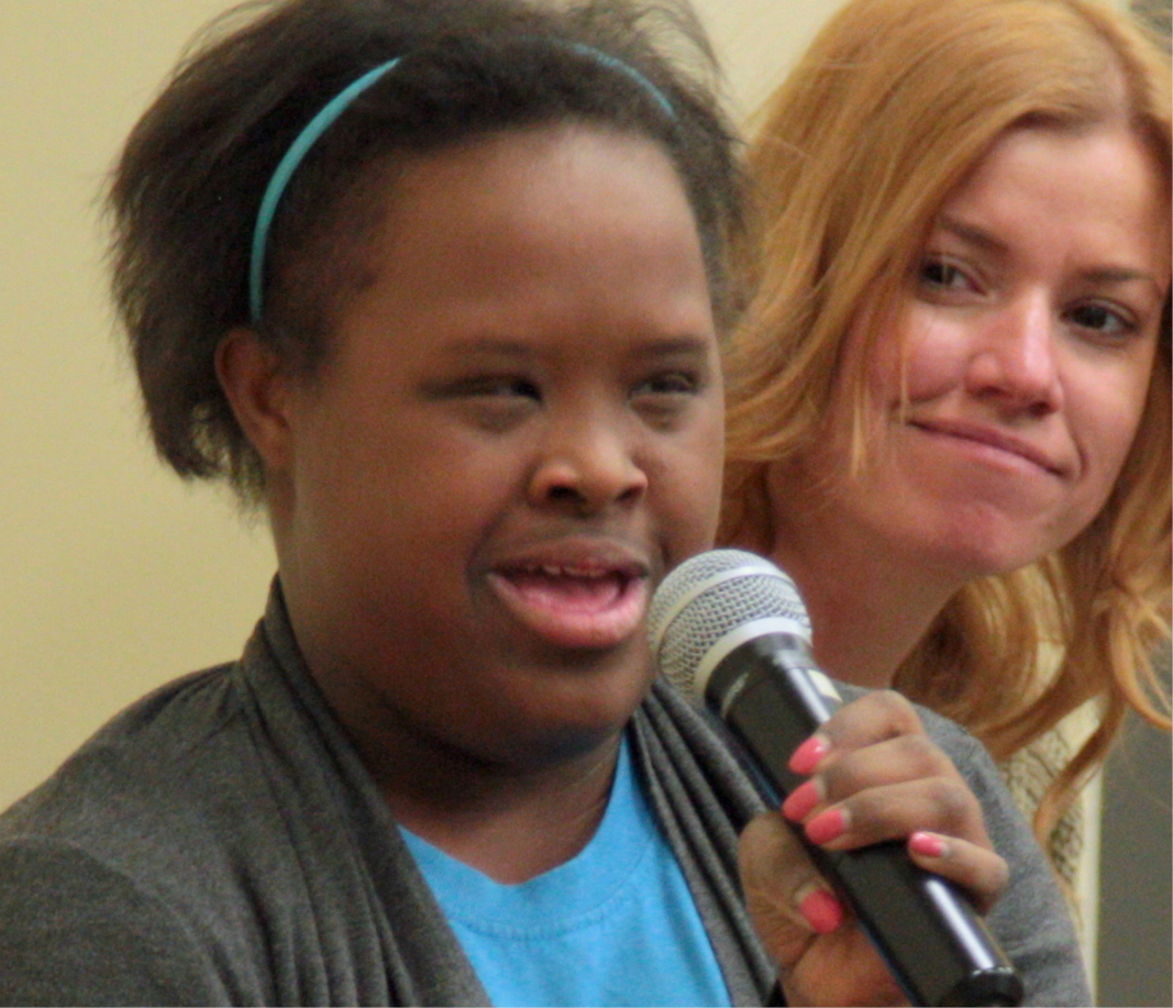 woman with down syndrome speaking to an audience