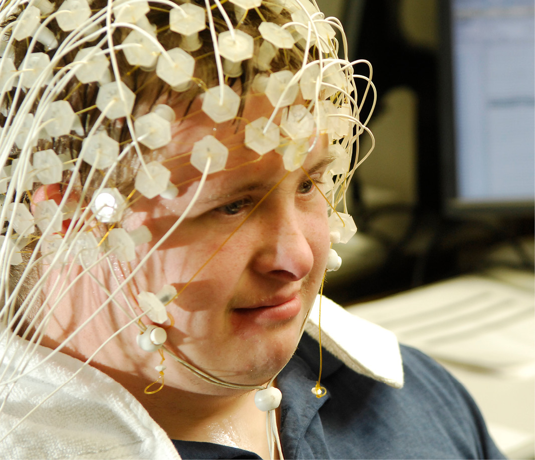 Young man wearing EEG net