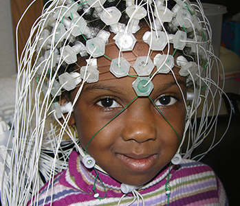 Young girl wearing EEG net