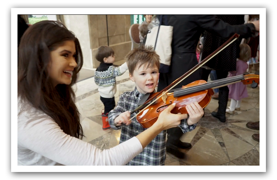 woman and young boy with violin