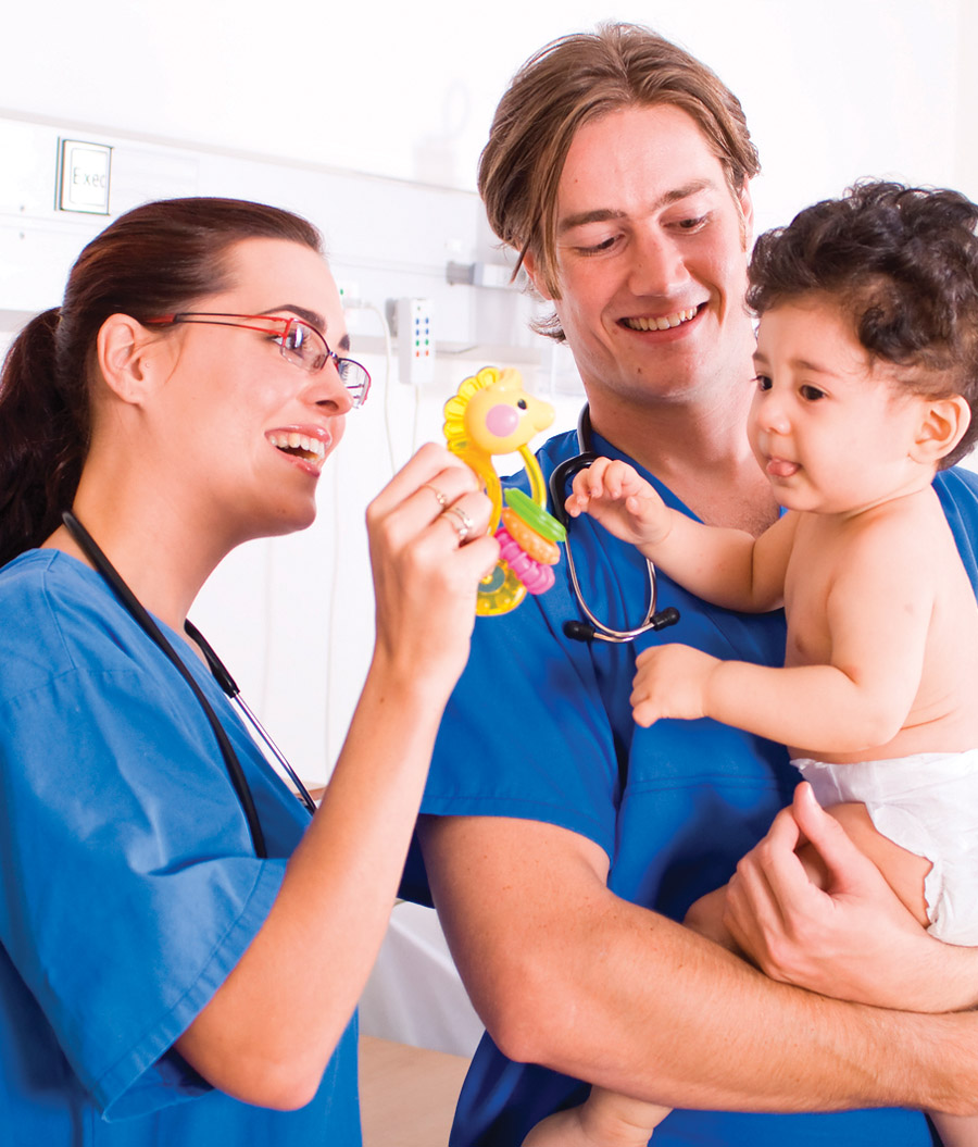 two health care professionals with young boy