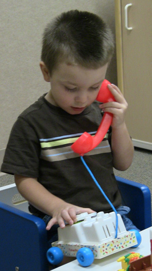 boy making a call on a toy phone