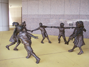 statue of children holding hands and playing